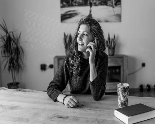 A person managing time and schedule using a physical planner at home